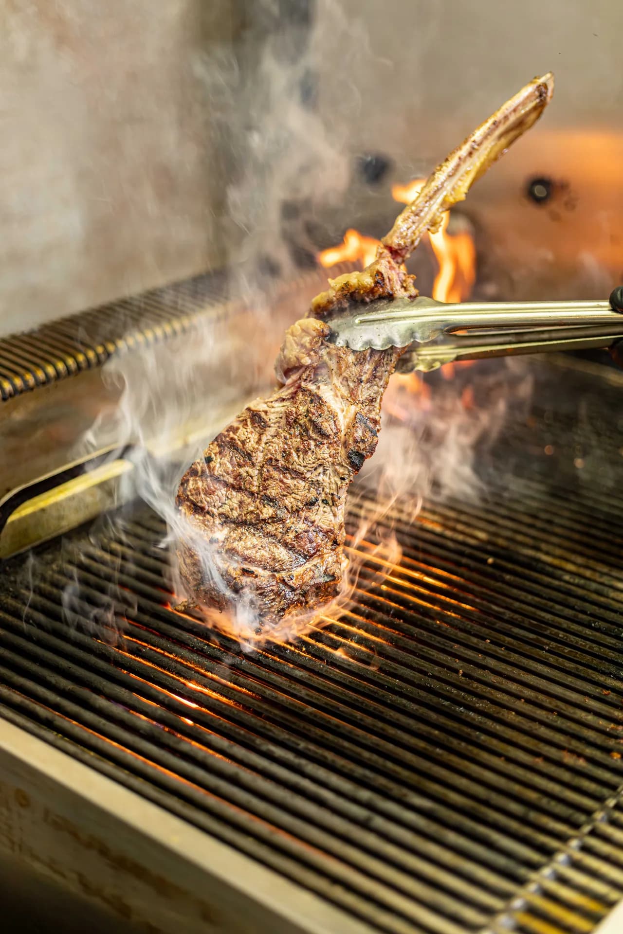 Lavigne steak lifted from grill.