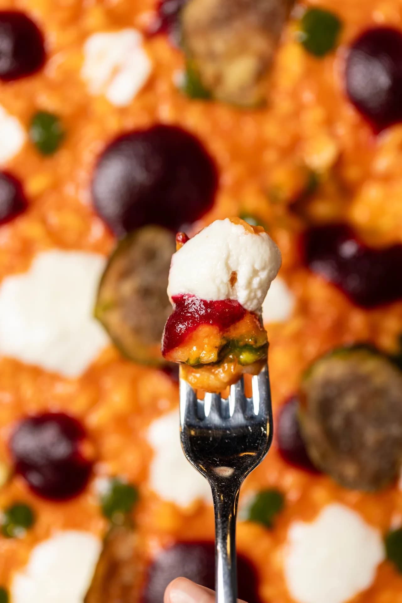 Mito pizza bite on fork.