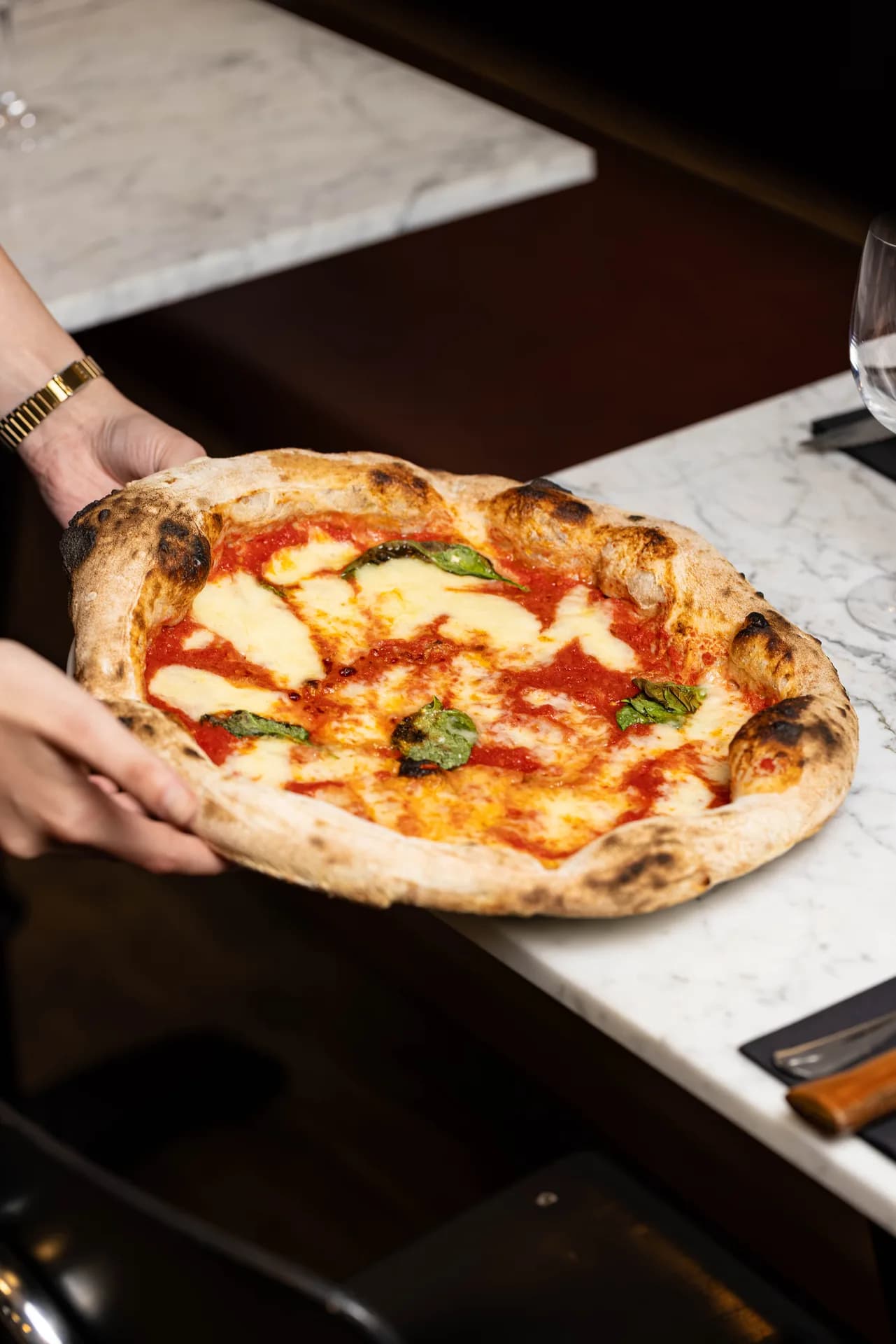 Margherita pizza being served at Mito.