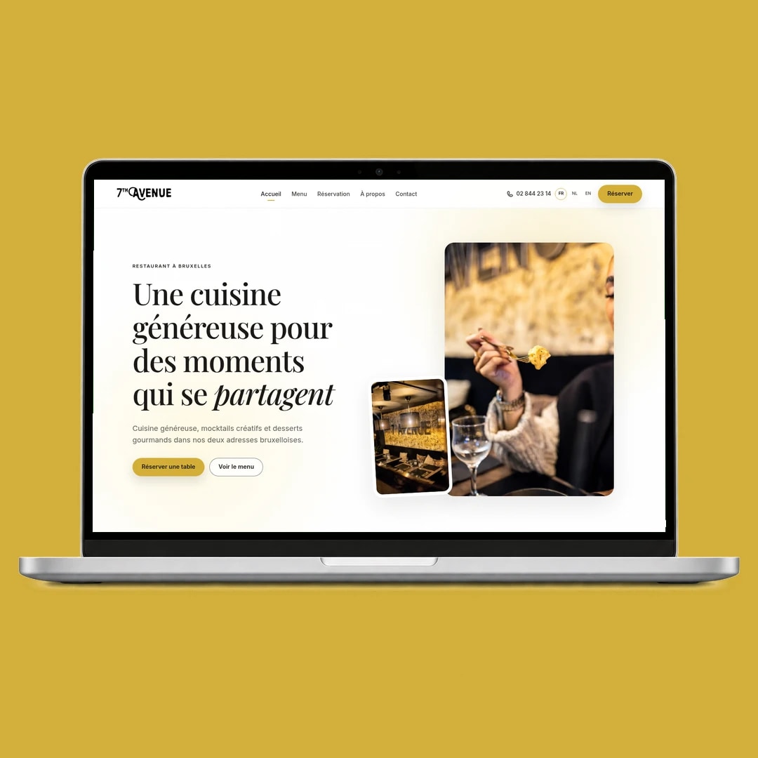 7th Avenue homepage displayed in a laptop mockup.