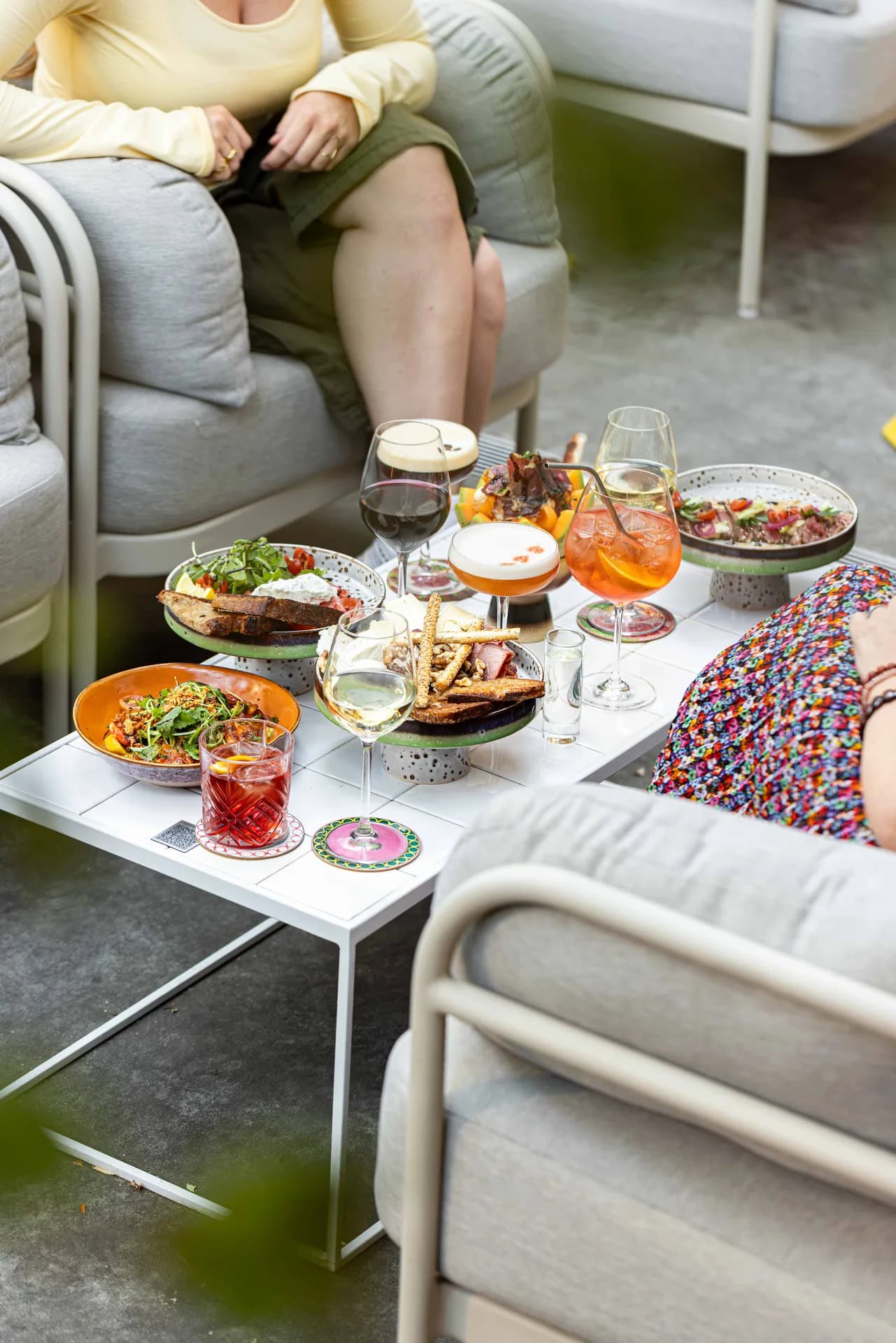 Guests sharing colourful food and drinks in a relaxed social setting.