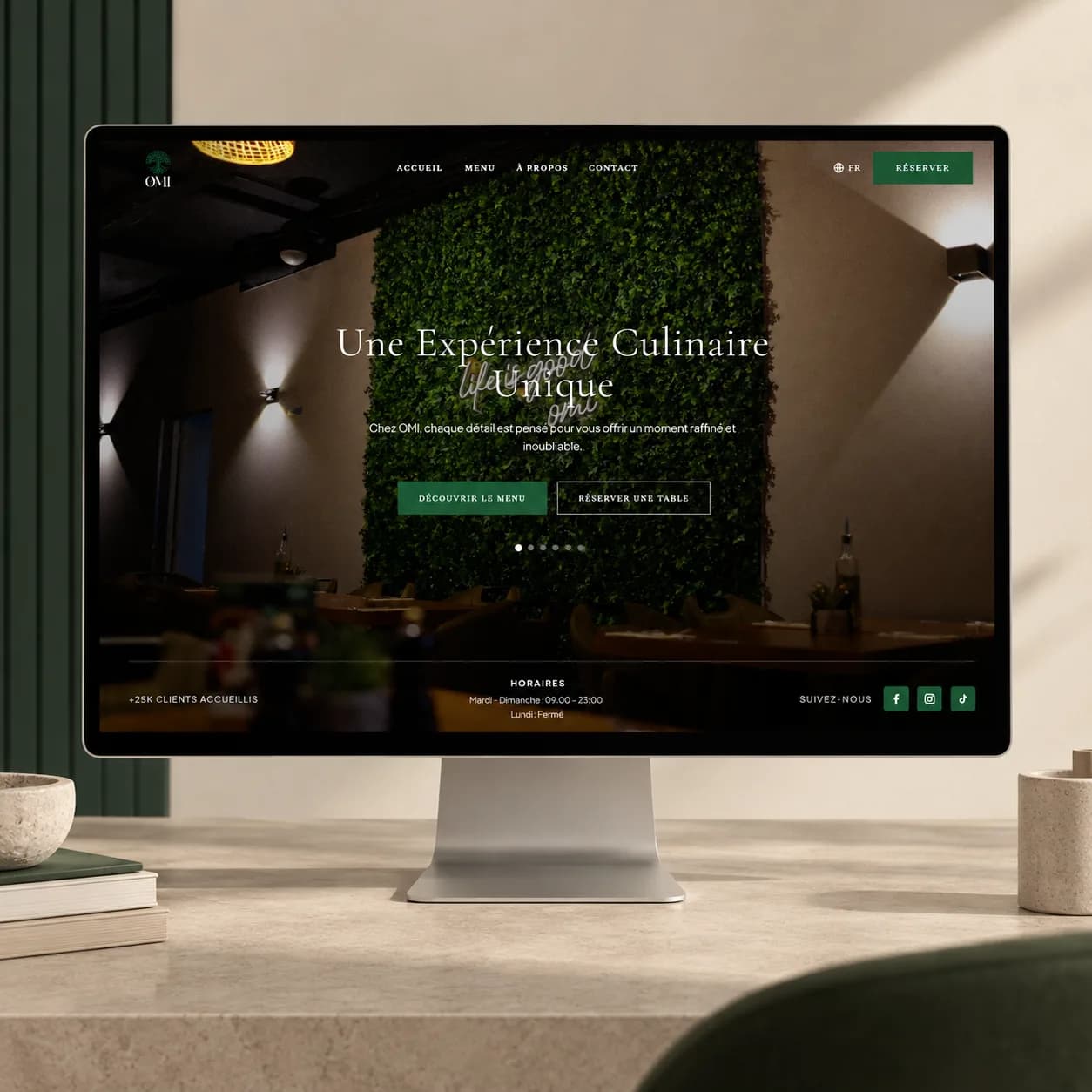 OMI restaurant website displayed on a desktop monitor mockup.